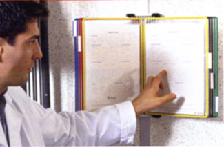 Man pointing to relevant data in his Tarifold wall mounted literature organizer.